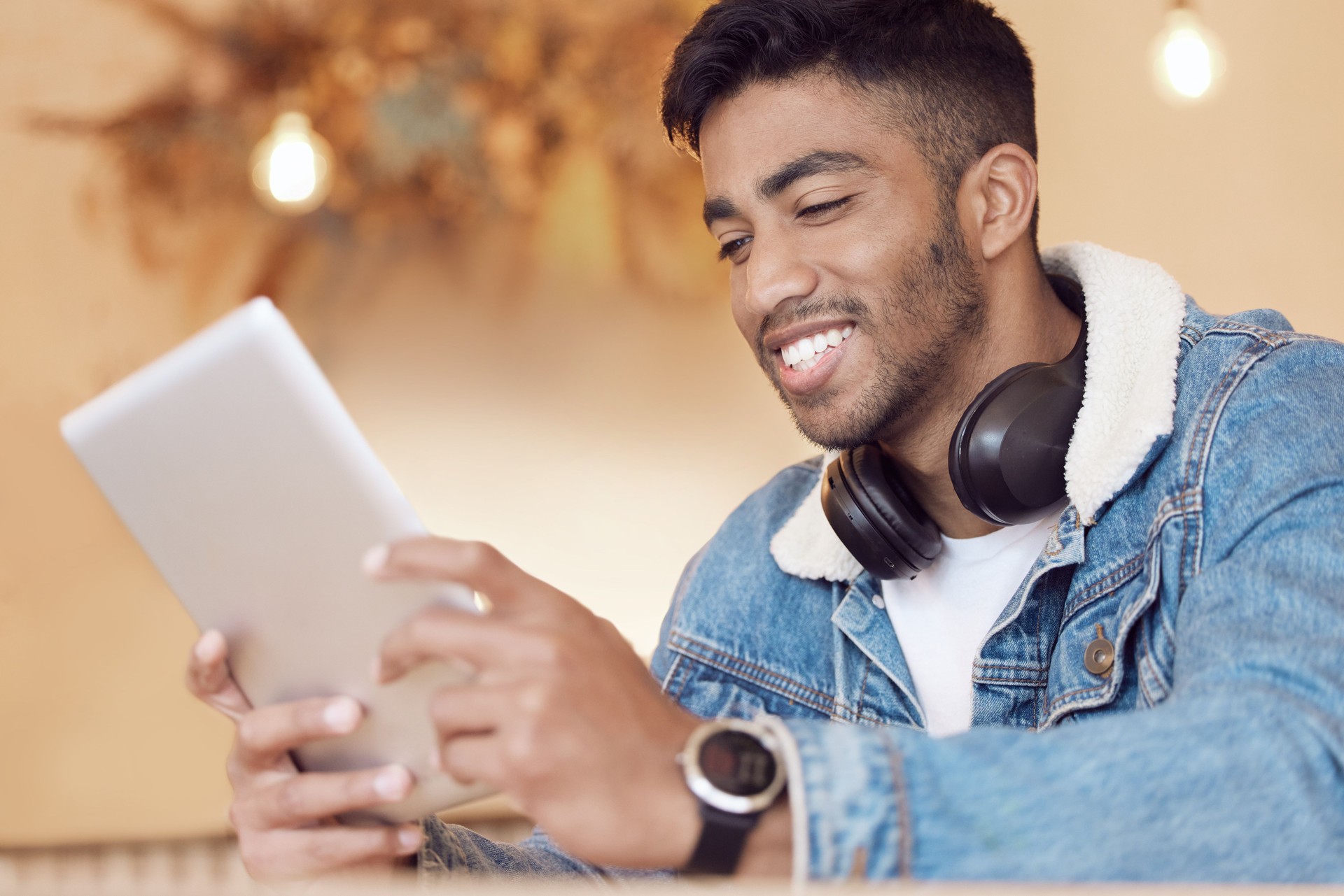 Shot of a young man using a digital tablet in a coffee shop